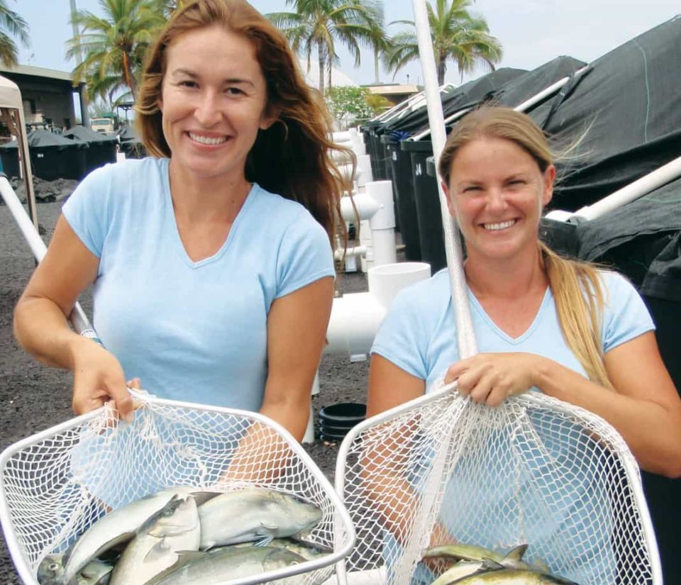 Women with fish in nets